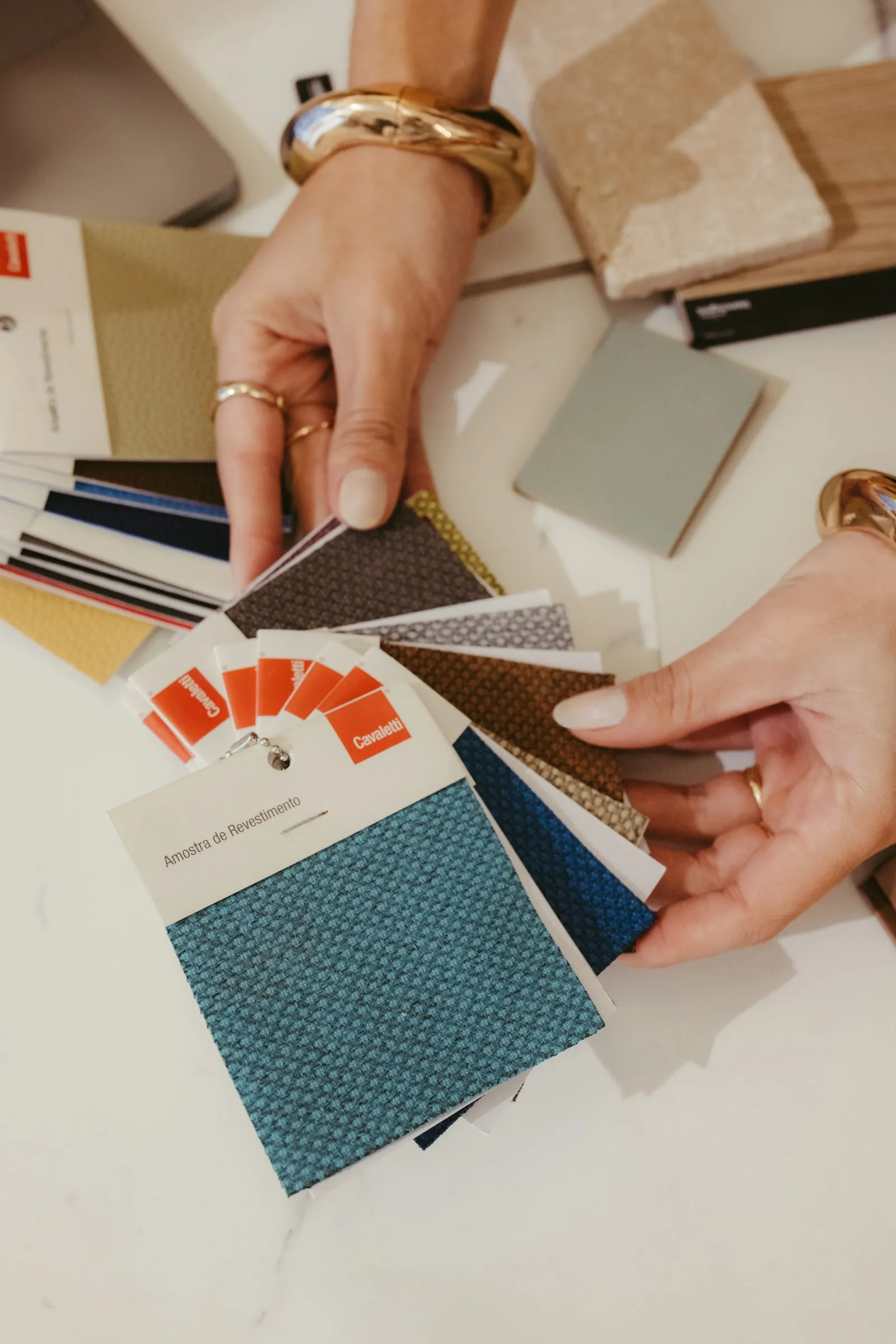 Choosing window treatment fabric samples during an in-home design consultation