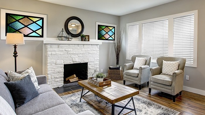 Aluminum blinds beside stained glass windows