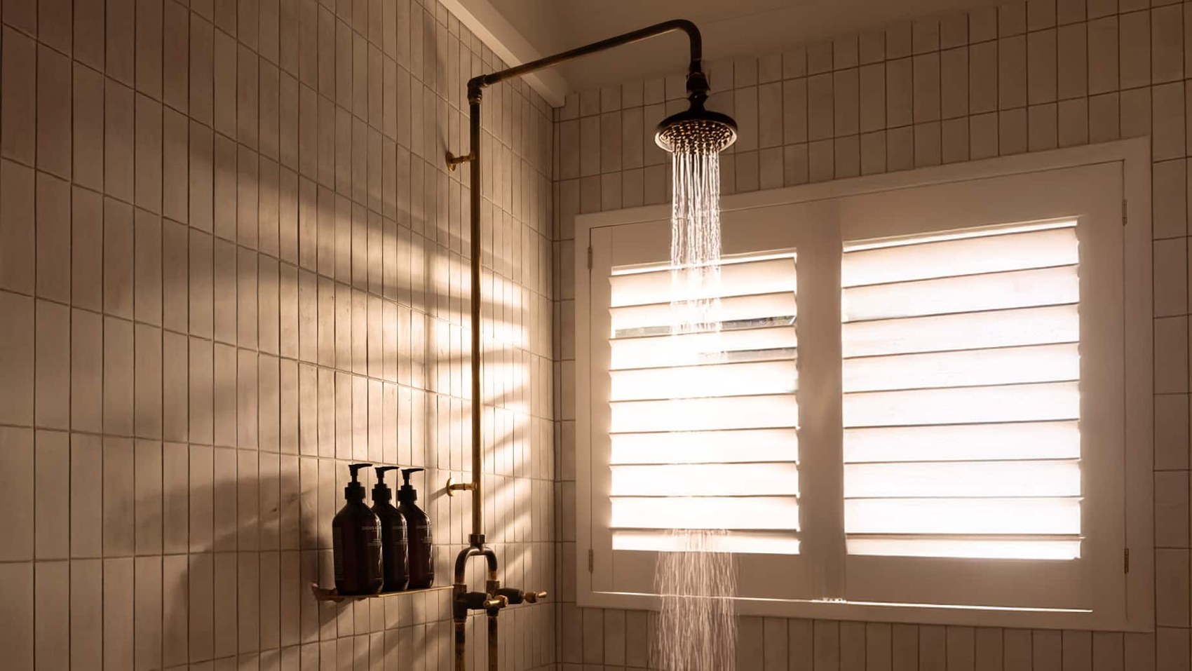 White shutters in a tiled walk-in shower