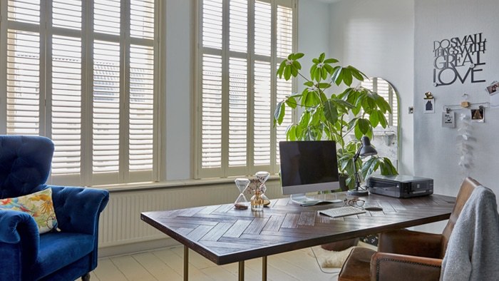Cream shutters in a home office