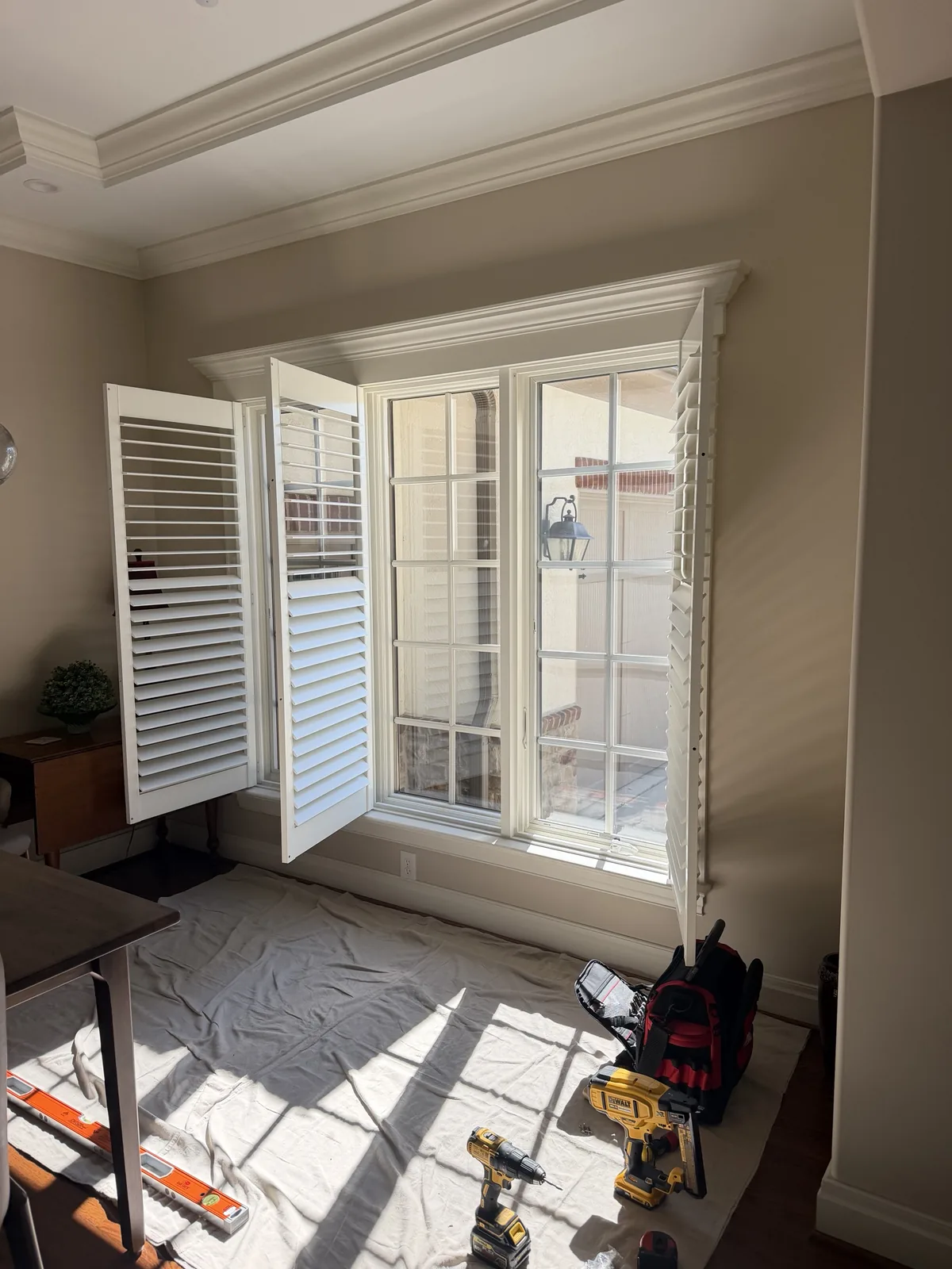 Norman plantation shutters installed on a large casement window in a Worthington, OH home